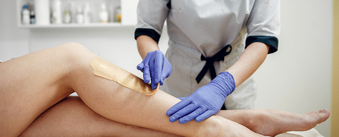 Professional waxing services being performed on legs at Salon77