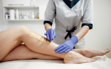 Professional waxing services being performed on legs at Salon77
