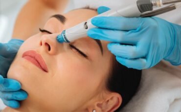 Woman receiving HydraFacial treatment at a clinic in Abbotsford