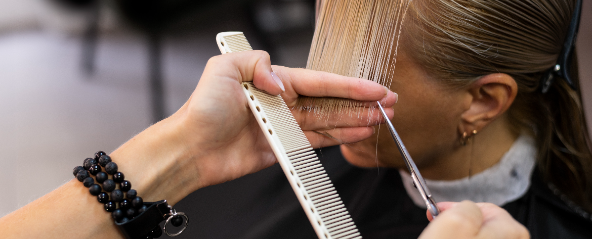 Stylist preparing a woman for a haircut in a modern Abbotsford salon